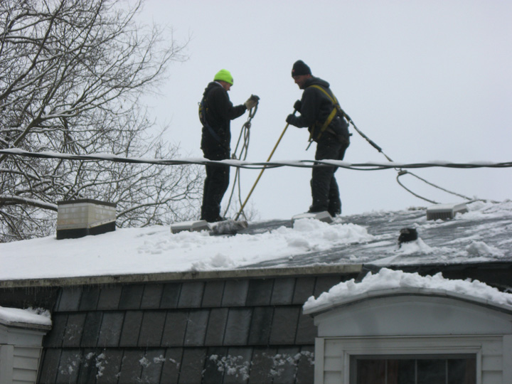 Charleswood Roofing crew performing professional rooftop snow removal in Winnipeg winter conditions
